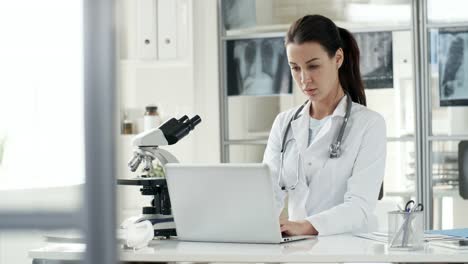 Female-Doctor-Typing-on-Laptop-Computer