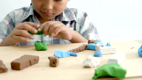 Child's-hands-playing-colorful-clay-on-table.-Development-of-fine-motor-skills-of-fingers-and-creativity,-education