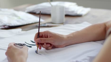 Creative-Woman-Painting-on-White-T-Shirt