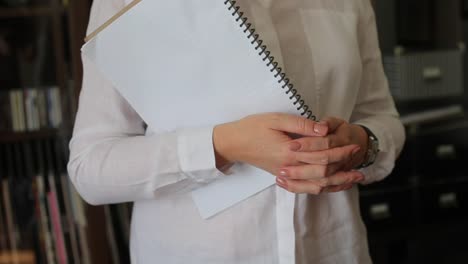 woman-holds-a-diary-in-her-hands