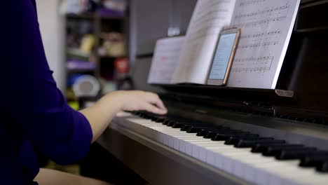 Hands-teenager-girl-playing-on-the-keyboard-of-the-digital-piano