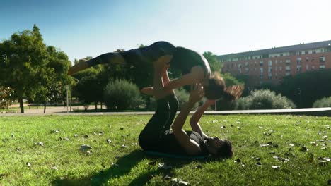 Beautiful-couple-practicing-acro-yoga-in-the-morning