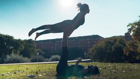 Beautiful-couple-practicing-acro-yoga-in-the-morning