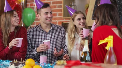 Smiling-people-drinking-champagne-during-fantastic-birthday-celebration,-spending-nice-time-together-at-the-weekend,-slowmotion-in-beautiful-studio-apartment