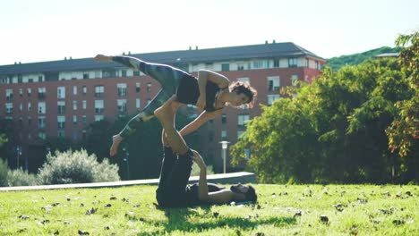 Beautiful-couple-practicing-acro-yoga-in-the-morning