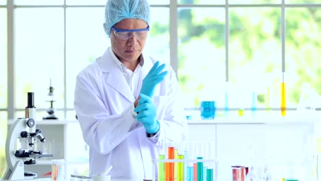 Scientist-put-on-gloves-working-in-lab