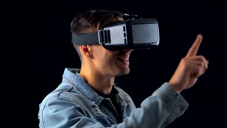 Portrait-of-Young-Man-using-VR-Glasses-on-Black-Background.-Male-Virtual-Reality-Console-Headset-Play-3D-Gaming-Innovation-Internet-Entertainment-Technology