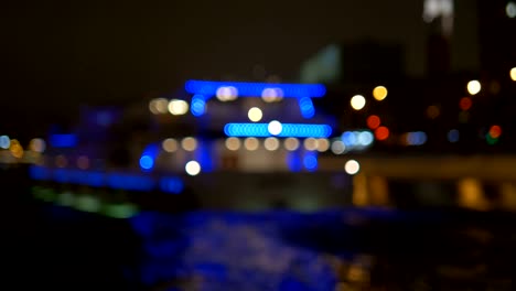 The-ship,-adorned-with-lights,-floats-along-the-river.-Not-in-Focus---Intentionally