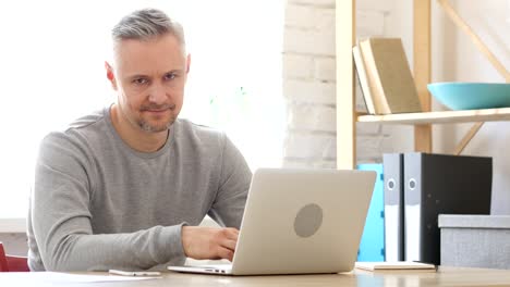 Shaking-Head-in-Denial,-Rejecting-Middle-Aged-Man-at-Work