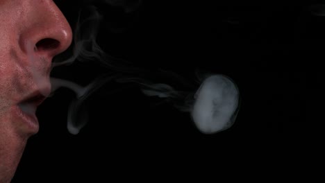 Man-smoking-a-Cigarette-against-Black-Background,-Slow-Motion-4K