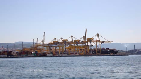 Industrial-Container-Cargo-freight-ship-with-working-crane-bridge-in-shipyard