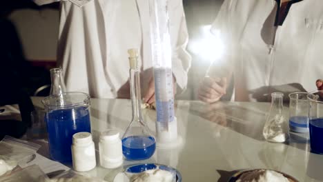 Scientist-working-with-chemical-reaction-in-chemistry-lab.