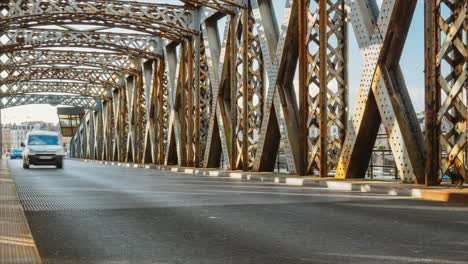 Time-lapse-of-cars-driving-on-the-asphalt-road-of-the-city-bridge-on-a-sunny-day.