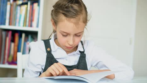 Cute-little-girl-is-reading-book.-Slow-motion.