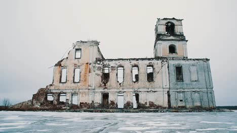 Destroyed-chapel-building-in-middle-of-frozen-lake-covered-in-snow