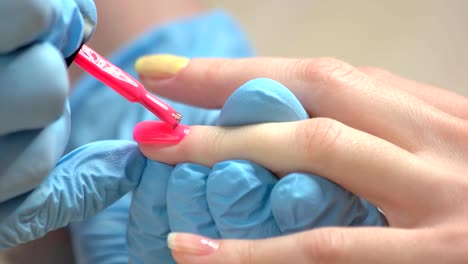 Manicurist-painting-nails-with-varnish.