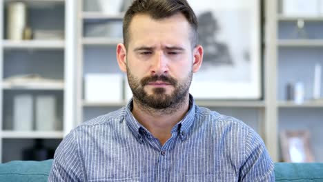 Portrait-of-Sad-Adult-Man-Looking-at-Camera