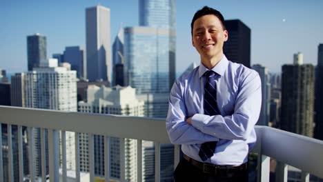 Portrait-of-Asian-American-businessman-on-Chicago-rooftop