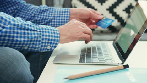 Businessman-Shopping-With-Laptop-And-Credit-Card-At-Table-4K