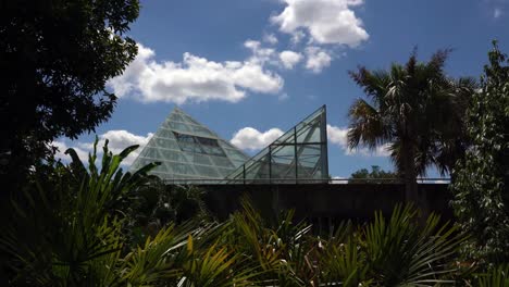 Panning-Video-of-Triangle-Shaped-Glass-Greenhouse-with-Blue-Sky-Background