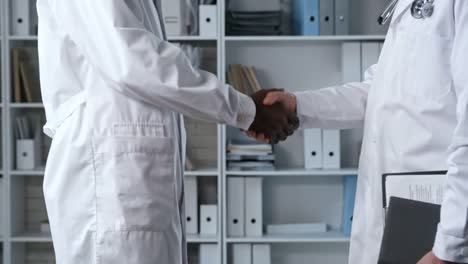 Unrecognizable-Doctors-Shaking-Hands-at-Meeting