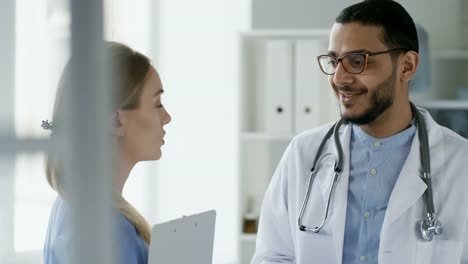 Multiethnic-Doctors-Talking-at-Work-in-Clinic