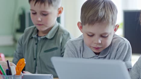 Schoolchildren-Talking-and-Using-Laptop-Computers