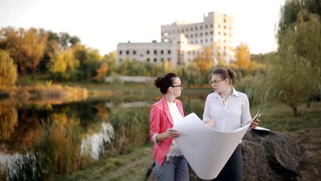 Architect-and-engineer-at-the-construction-site-check-in-accordance-with-the-documentation.