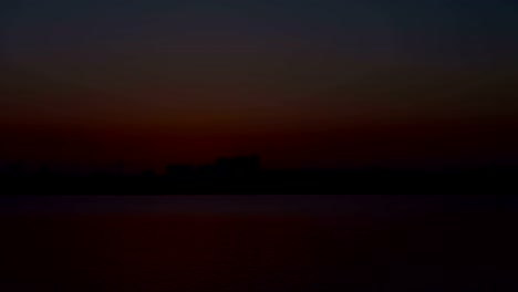 Sunset-with-urban-buildings-on-horizon-time-lapse