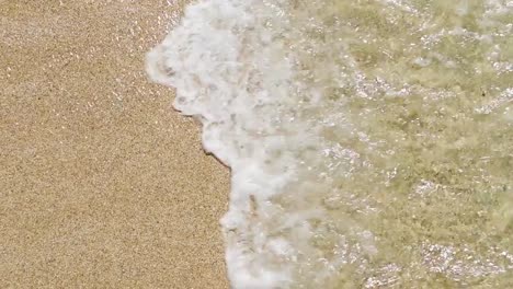 slow-motion-of-waves-breaking-at-the-shoreline-of-Pedn-Vounder-Beach,-Cornwall