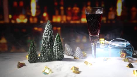 Glass-of-wine-with-Christmas-decoration.-Red-wine-in-crystal-glass-on-snow-with-creative-New-Year-artwork.-Copy-space