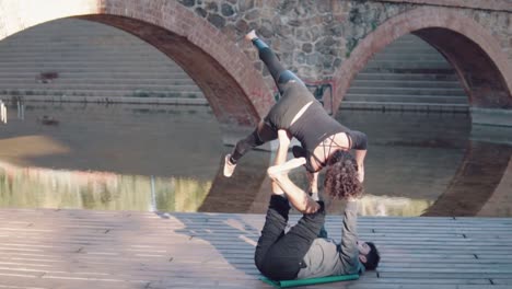 Beautiful-couple-practicing-acro-yoga-in-the-morning