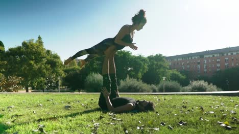 Beautiful-couple-practicing-acro-yoga-in-the-morning