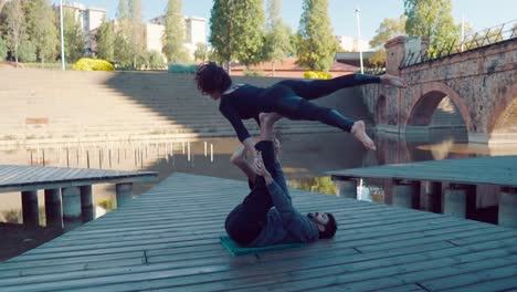 Beautiful-couple-practicing-acro-yoga-in-the-morning