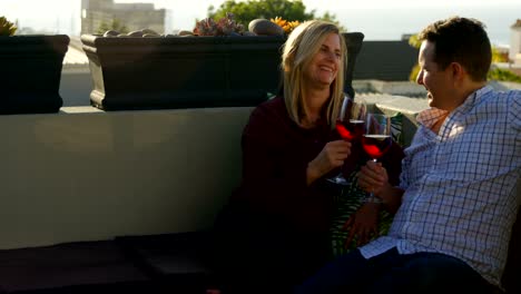 Happy-couple-having-red-wine-in-the-balcony-at-home-4k