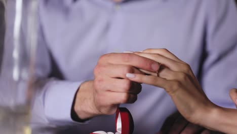 Marriage-Proposal.-Closeup-Man-Wearing-Ring-On-Woman's-Hand