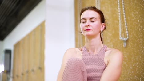 Young-woman-stretching-in-yoga-studio-in-slow-motion