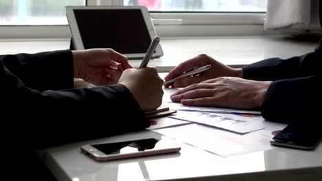 Colleagues-Planning-Together-With-Graph-In-The-Office