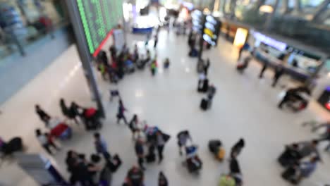 Top-view-of-abstract-blur-airport-terminal-with-commuter-crowd-of-people-and-passenger-walking-when-track-arriving-or-departing-flights,-Blurred-busy-Airport-Terminal-footage-concept.-Full-HD1920x1080