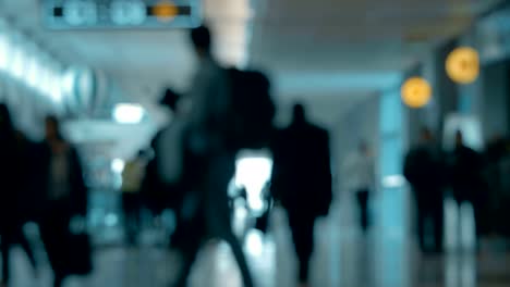 Airport-hall-with-walking-people,-defocus