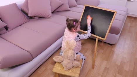 Small-girl-cleaning-blackboard