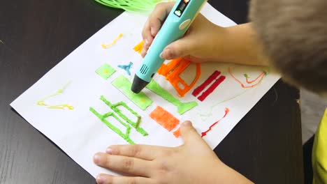 child-draws-details-of-the-helicopter-with-3D-pen