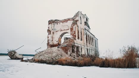 Destroyed-orthodoxal-church-in-middle-of-frozen-lake-covered-in-snow