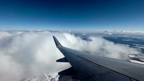 Flug-in-einem-Flugzeug.-Flügel-eines-Flugzeugs-in-den-Wolken.-Blick-vom-Flugzeug