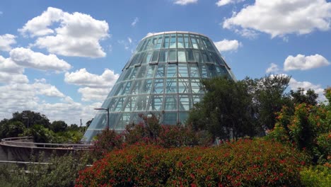 Greenhouse-Glass-Structure-with-Blue-Sky-Background-Close-Up-Panning-Video