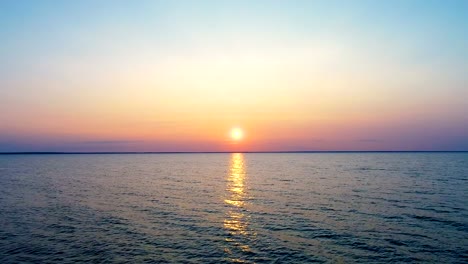 The-flight-above-the-sea-on-the-sunrise-background.-drone-shot