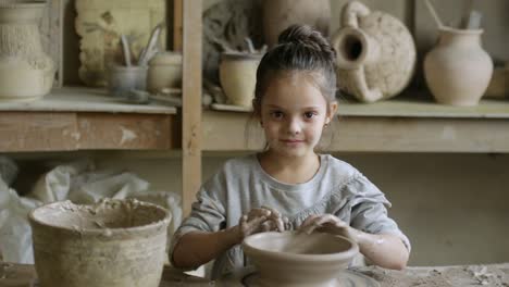 Little-Girl-Making-Pottery-in-Ceramics-Class