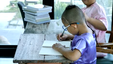 Asian-boy-two-people-with-writing-homework.-education-concept