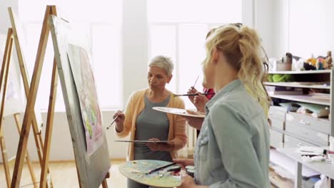 students-with-easels-painting-at-art-school