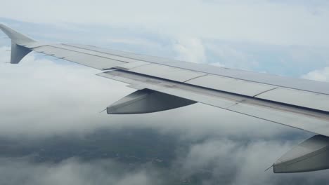 The-wing-of-the-aircraft-when-landing-for-stop-on-a-weather-bad-day-on-cloud